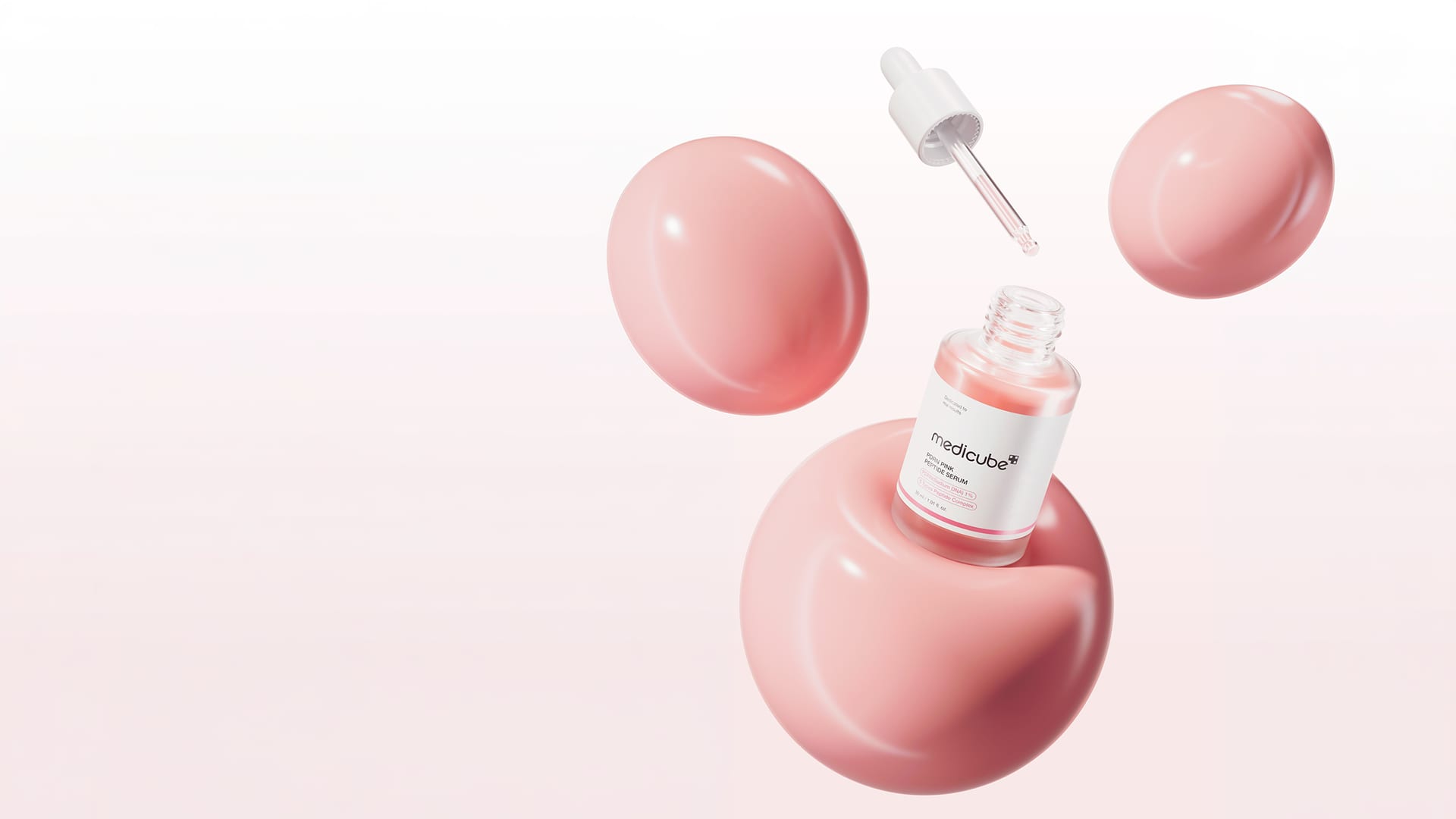 Pipettenflasche eines koreanischen Hautpflege-Serums zwischen zarten rosa Kugeln vor hellem Hintergrund